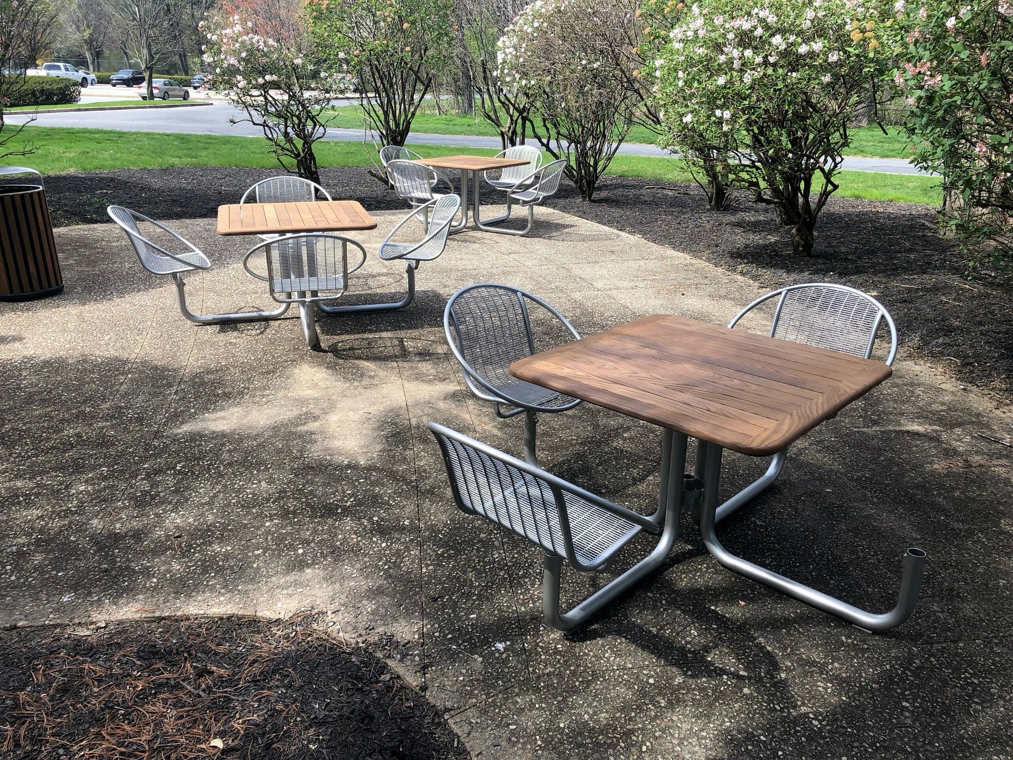 outdoor seating area with tables and chairs biophilia outdoor furniture workplace