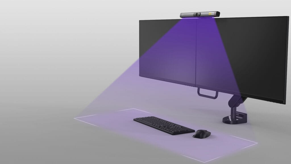 computer monitor with mounted UVIO Light shining on desktop